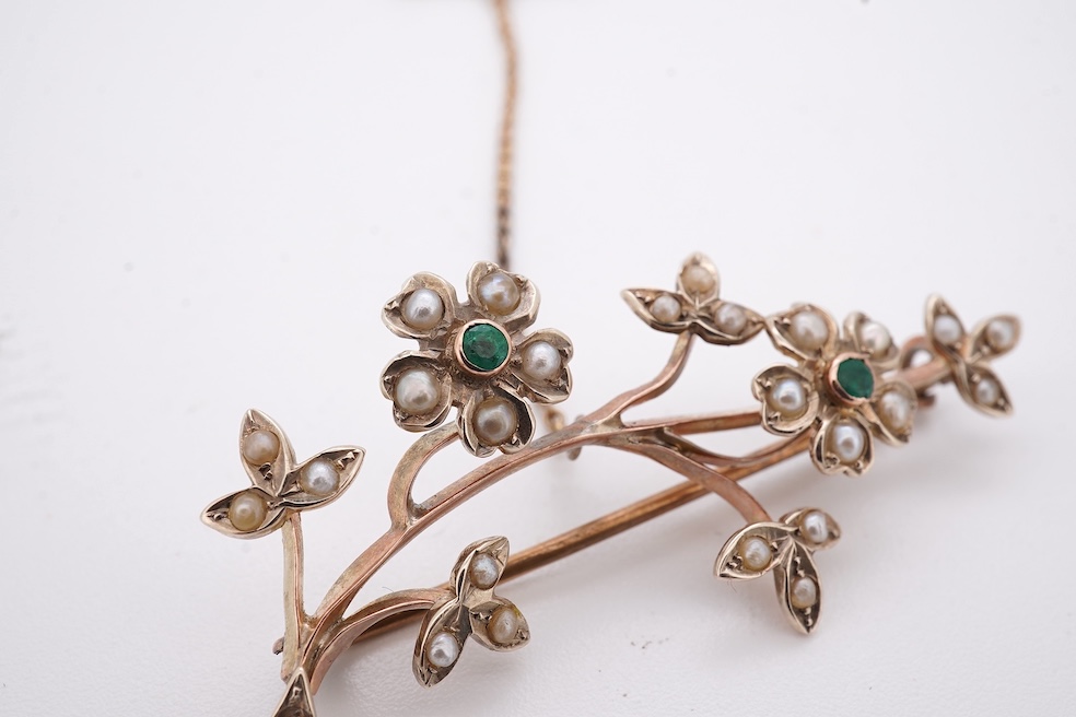 An early 20th century 9ct, seed pearl and emerald cluster set floral spray brooch, 45mm, gross weight 4.4 grams. Condition - poor to fair